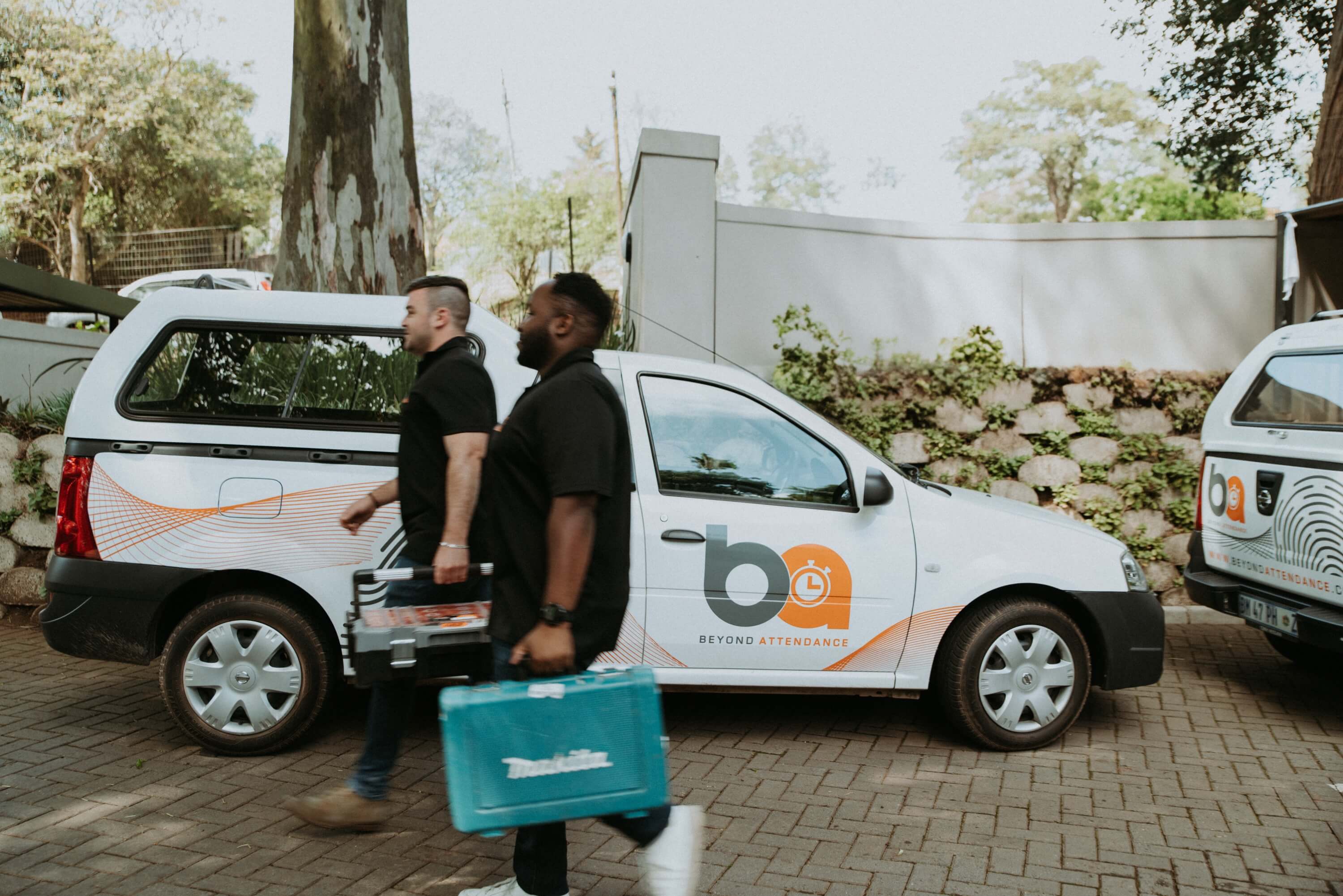 Mobile construction team members in South Africa using portable time tracking devices at remote work site